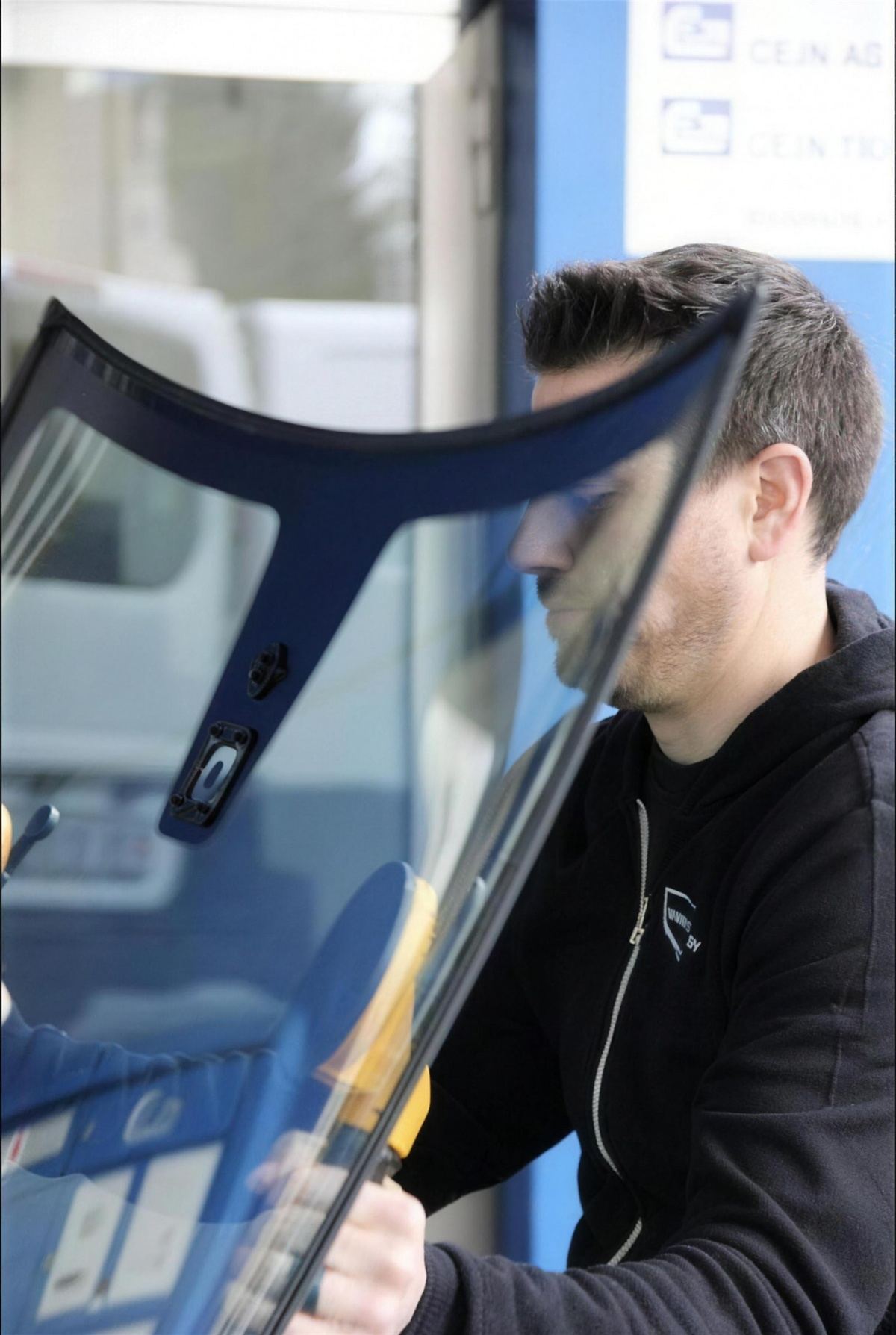 Timo Hofstetter carrying a new windscreen to the vehicle