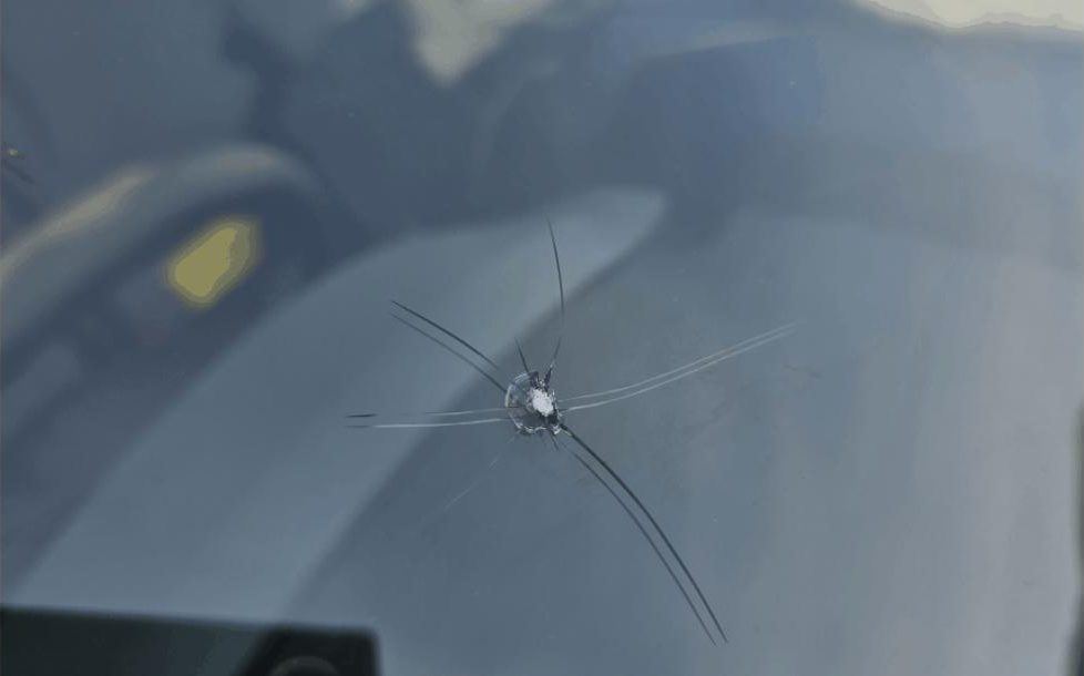 Stone chip with cracks in a windscreen, a typical partial comprehensive glass claim